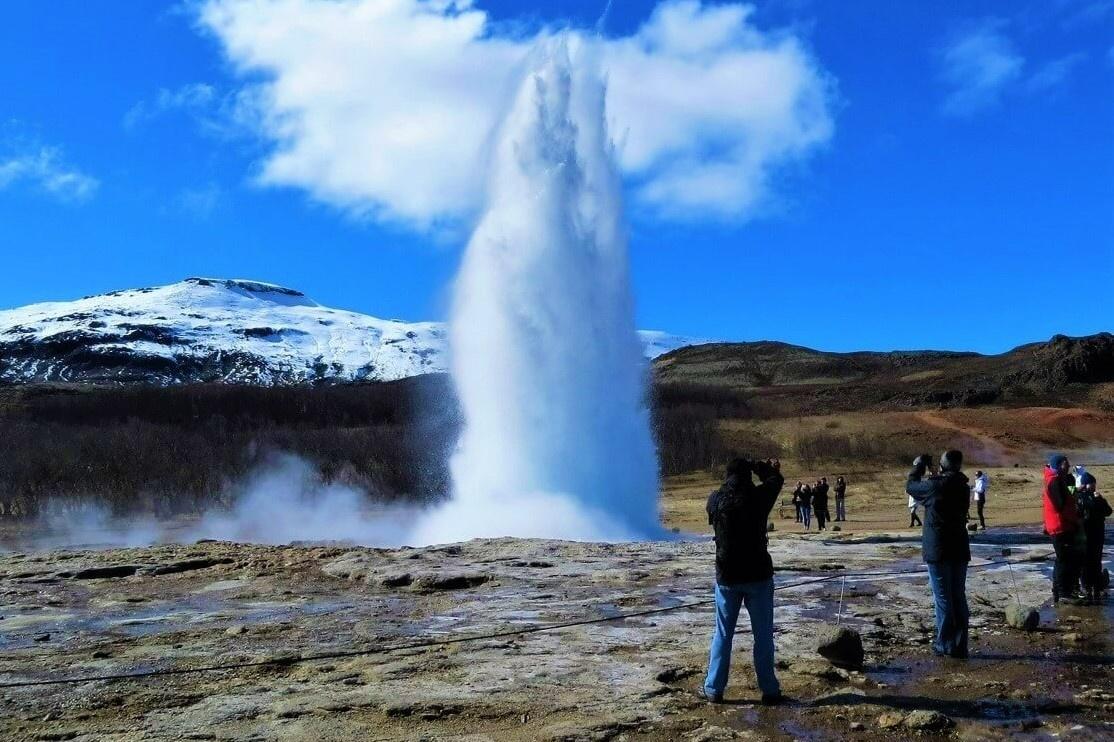 Geysir in Iceland with photographer nice weather